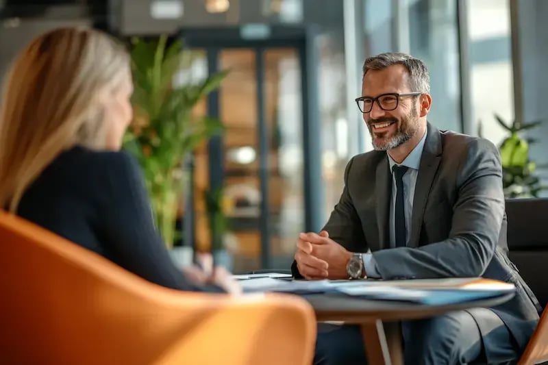 man-suit-smiling-at-a-table